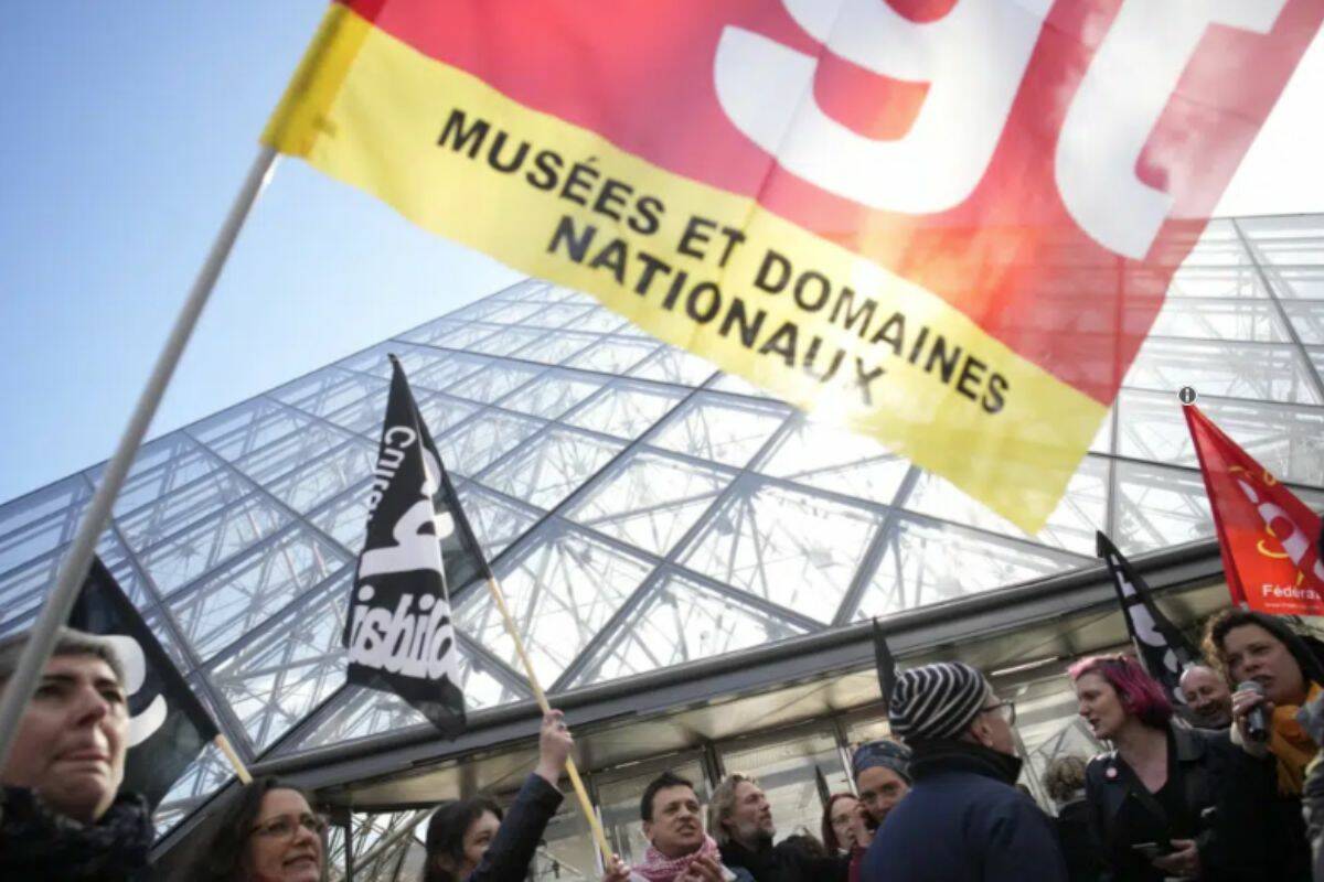 Workers of the culture industry demonstrate outside the Louvre museum Monday, March 27, 2023 in Paris. President Emmanuel Macron inflamed public anger by sending his already unpopular plan to raise the retirement age by two years, from 62 to 64, through parliament without a vote. (AP Photo/Christophe Ena)