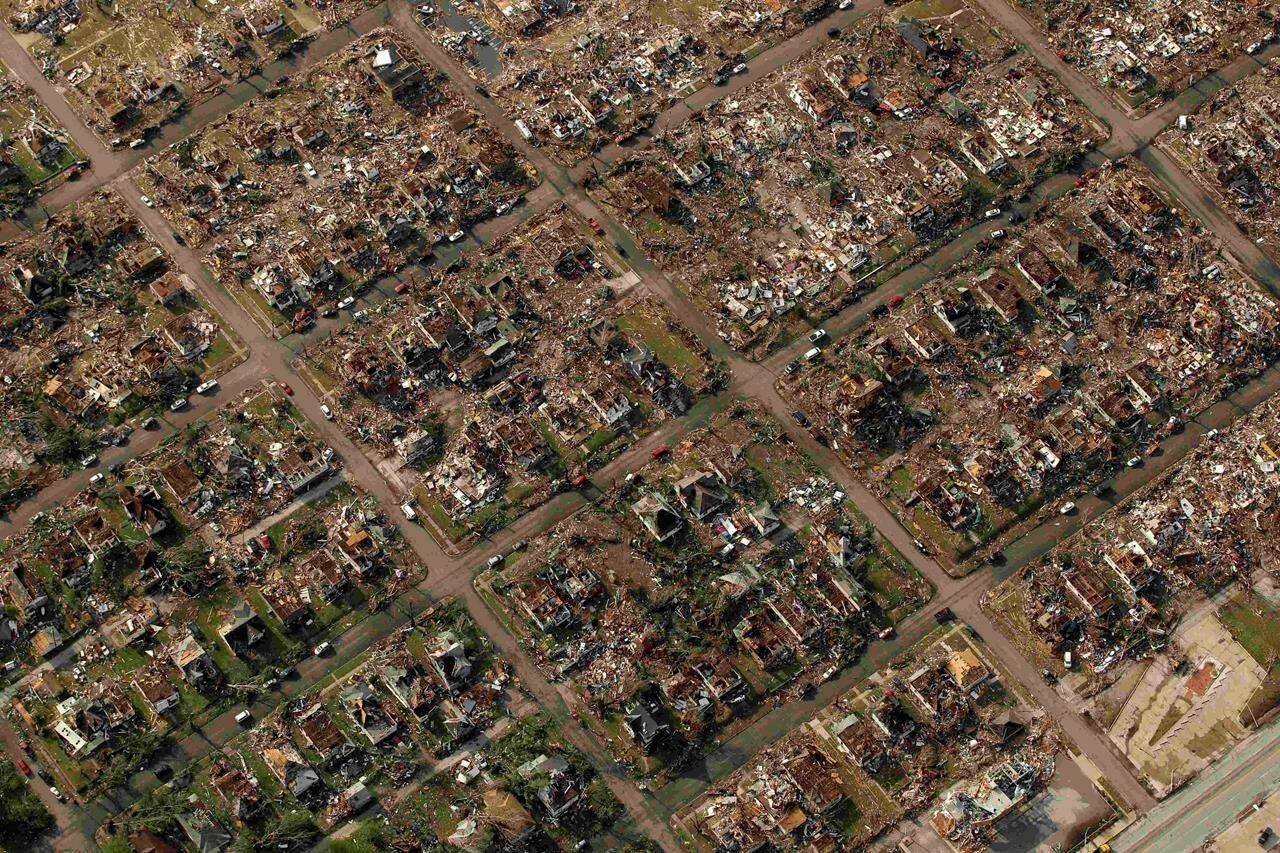 FILE - A neighborhood destroyed by a tornado is seen in Joplin, Mo., May 24, 2011. A new study says warming will fuel more supercells or tornados in the United States and that those storms will move eastward from their current range. (AP Photo/Charlie Riedel, File)
