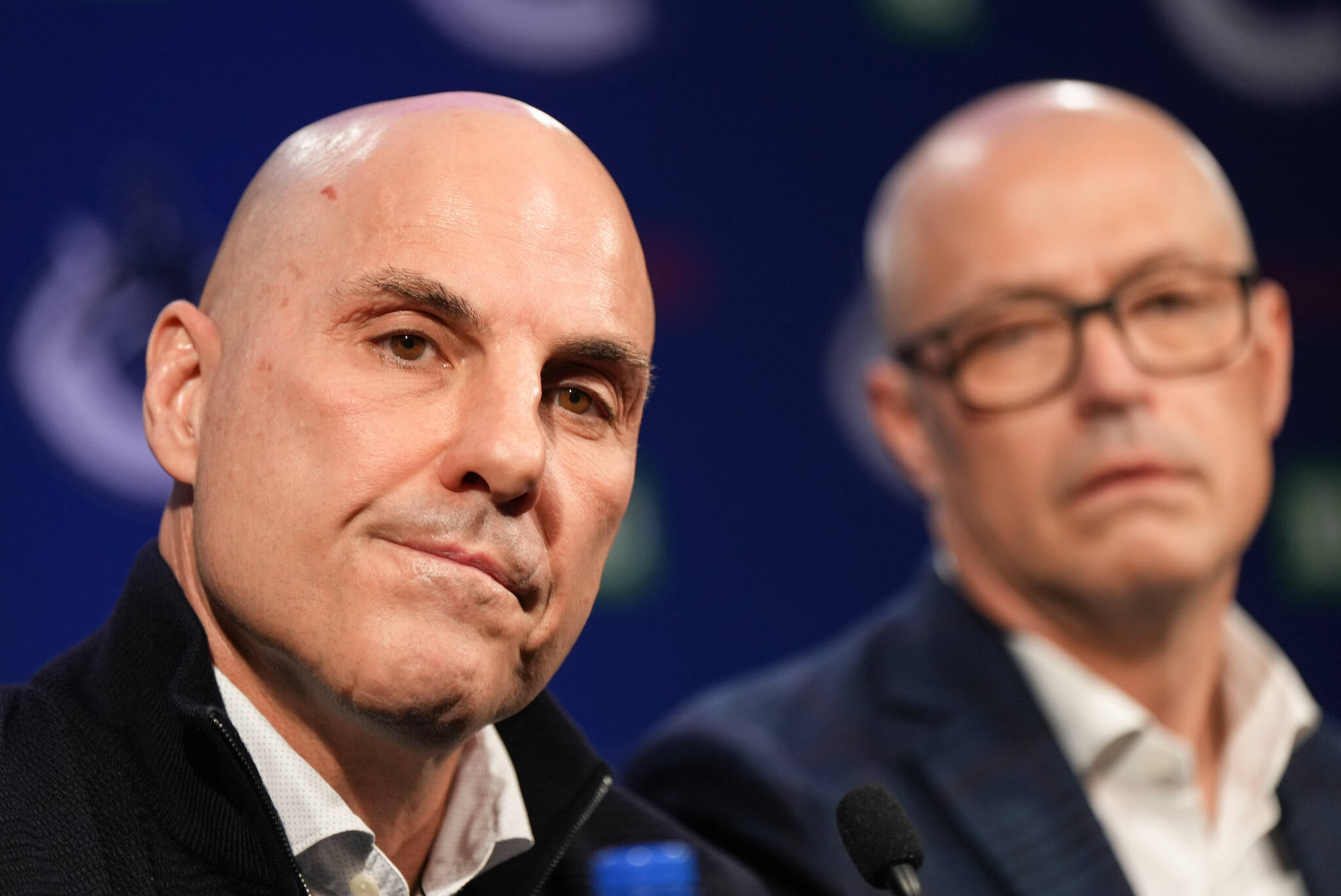 Vancouver Canucks head coach Rick Tocchet, front left, and general manager Patrik Allvin listen during a news conference after the NHL hockey team announced Tocchet’s hiring, in Vancouver, on Sunday, January 22, 2023. THE CANADIAN PRESS/Darryl Dyck
