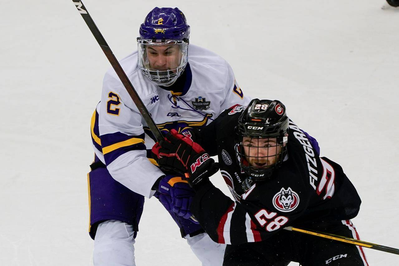 Minnesota State’s Akito Hirose (2) and St. Cloud State’s Kevin Fitzgerald (28) watch the puck during the third period of an NCAA men’s Frozen Four hockey semifinal in Pittsburgh, Thursday, April 8, 2021. The Vancouver Canucks have signed free-agent defenceman Hirose to a two-year, entry-level contract, the team announced Wednesday. THE CANADIAN PRESS/AP-Keith Srakocic
