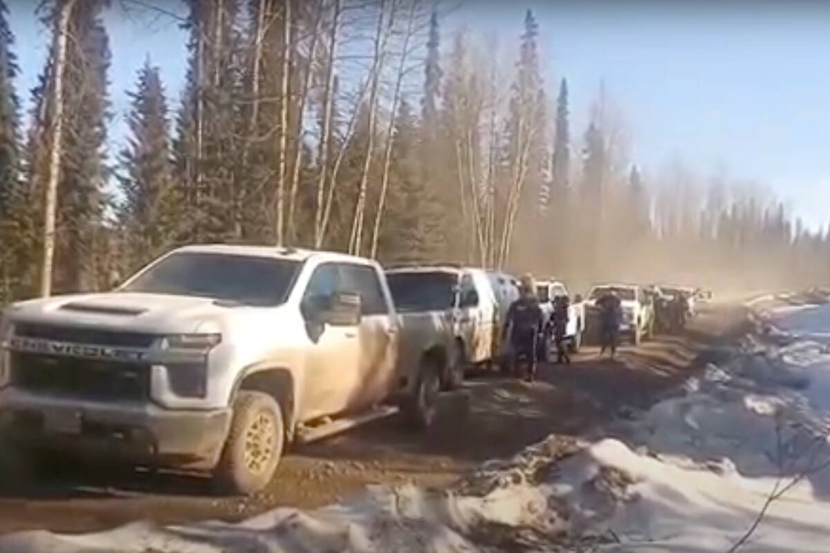 RCMP arrive at the 44.5 kilometre point of the Morice West Forest Service Road on March 29 to execute a warrant obtained following an incident in which a Coastal GasLink worker was allegedly swarmed by a group of masked individuals on March 26. (Yintah Access video screen capture)