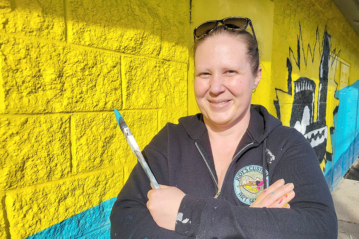 It took Langley City artist Judy Pohl about three hours to completely eradicate anti-Semitic slurs and a swastika from the mural she painted on the Langley Baseball clubhouse and concession in City Park. She finished painting over the graffiti Wednesday afternoon, March 29. (Dan Ferguson/Langley Advance Times)