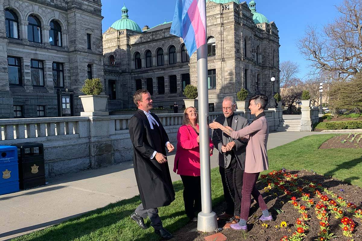Raising of the transgender flag on Thursday, March 30, 2023, outside the provincial legislature in Victoria, B.C. From left: Deputy Speaker Spencer Chandra Herbert, Parliamentary Secretary for Gender Equity Kelli Paddon, Aaron Devore, Chair in Transgender at the University of Victoria, and Alex DeForge, social impact coordinator of the Vancouver-based queer and trans resource centre QMUNITY. (Wolf Depner/Black Press Media