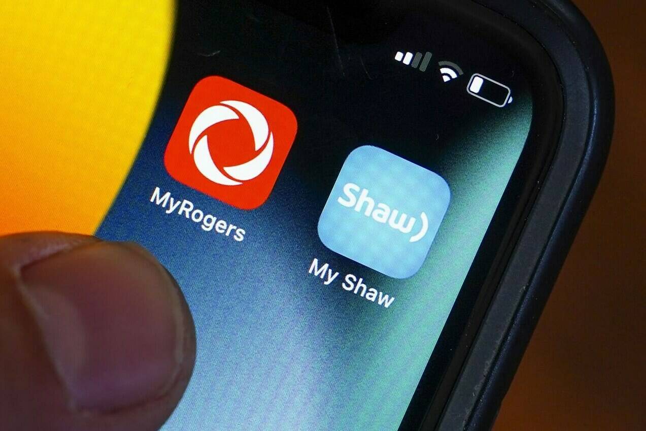 Rogers and Shaw applications are pictured on a cellphone in Ottawa on Monday, May 9, 2022. THE CANADIAN PRESS/Sean Kilpatrick