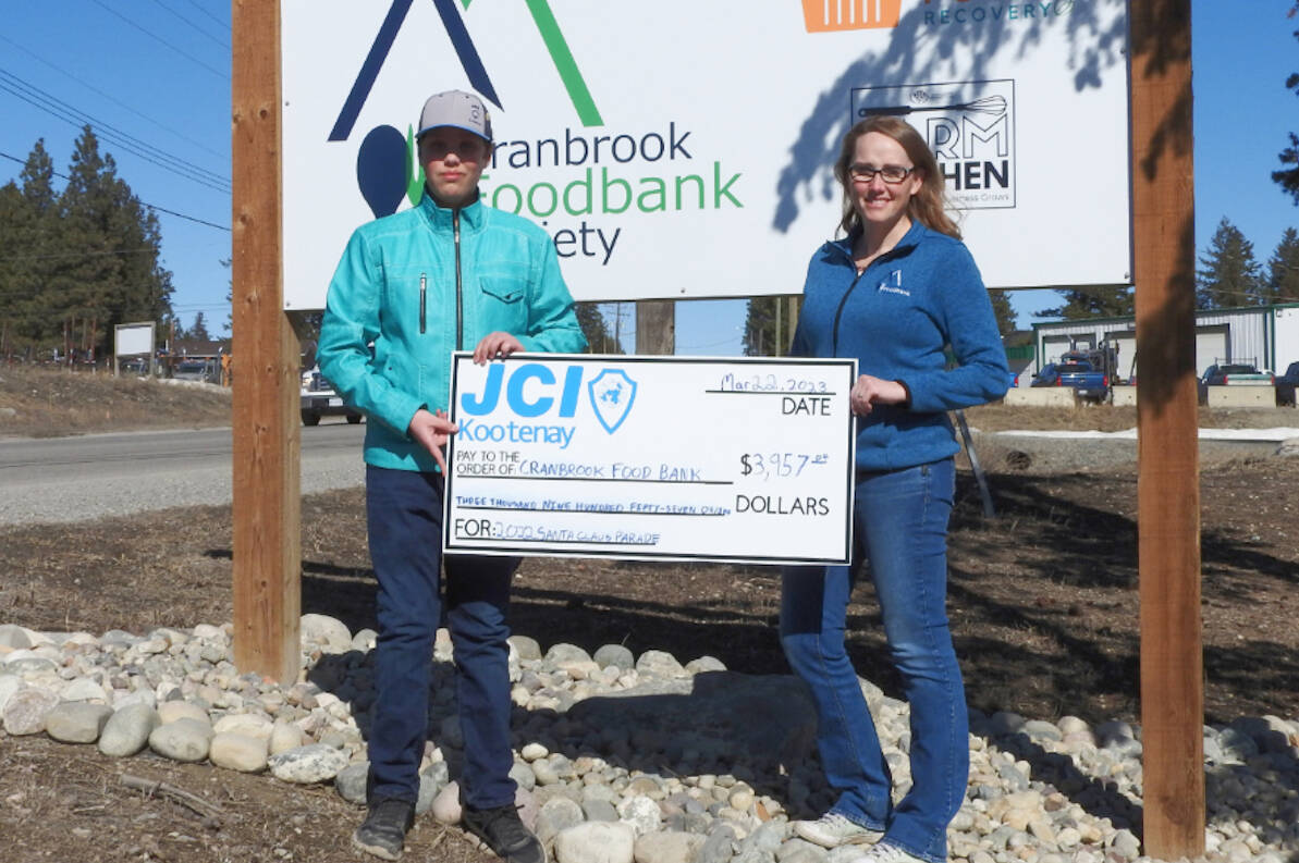 Santa Claus Parade chair Shane Nickel-Thibodeau handed Cranbrook Foodbank Society volunteer coordinator Rachel Wolff a cheque for $3,957.03 on March 22. The money will go towards obtaining food essentials to feed locals in need (photo by Gillian Francis)