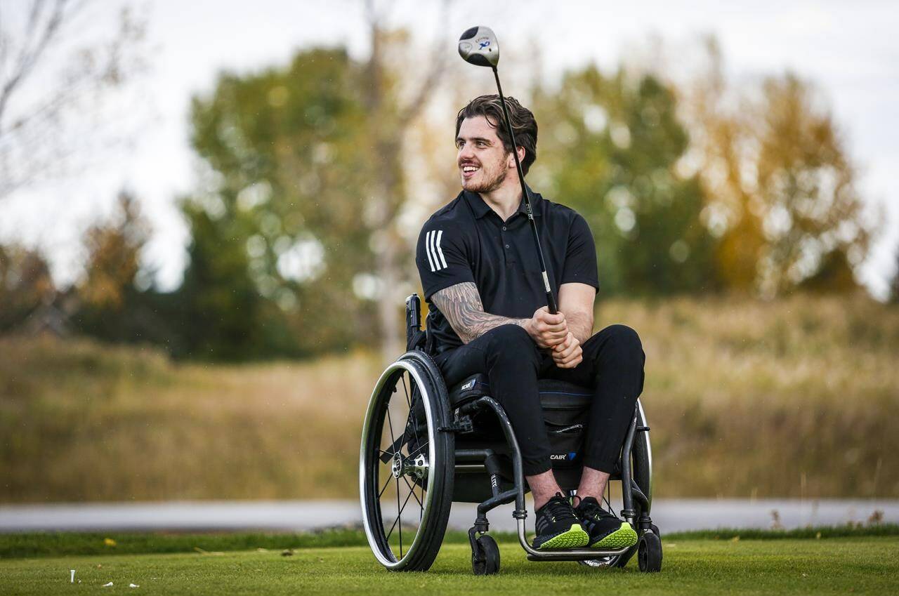 Humboldt Broncos bus crash survivor Ryan Straschnitzki pauses during a para golf lesson in Calgary, Tuesday, Sept. 28, 2021. Spending the last five years using a wheelchair has given former Humboldt Broncos hockey player Ryan Straschnitzki a new path forward. THE CANADIAN PRESS/Jeff McIntosh