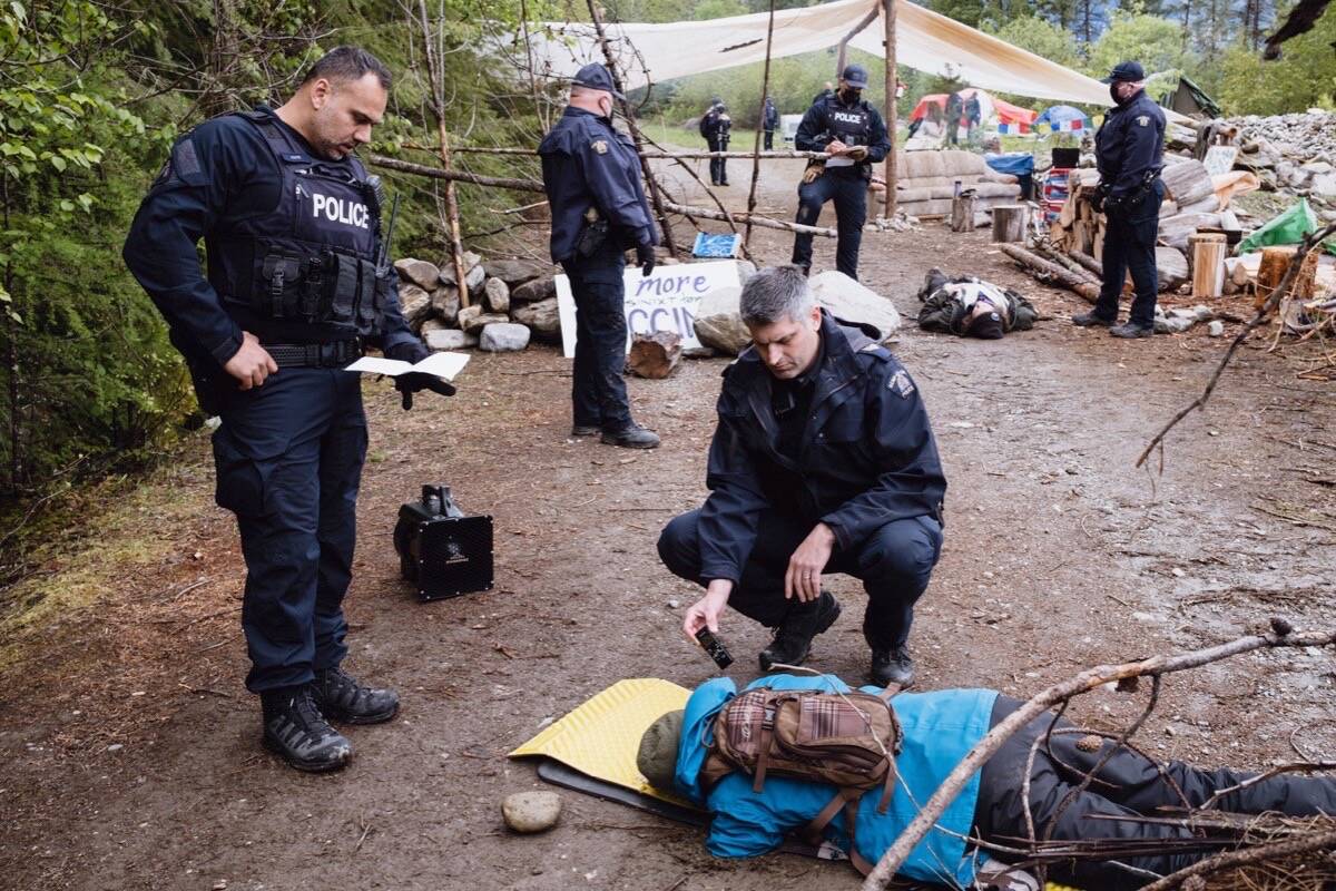 RCMP are seen here making arrests May 17, 2022 near Argenta, B.C., north of Nelson. A group had been camped out protesting a logging company’s plans for the area. Photo: Louis Bockner