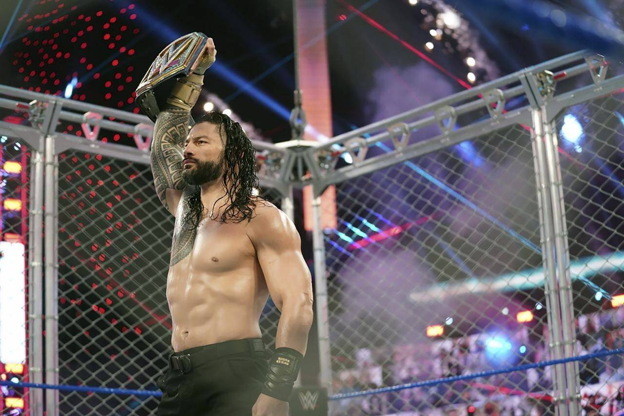 Roman Reigns holds up the WWE Universal Championship after defeating Jey Uso during a match on Oct. 25, 2020, in Orlando, Florida. Reigns and Cody Rhodes will be in the main event of WrestleMania 39 on April 2, 2023, in Los Angeles. (WWE via AP)