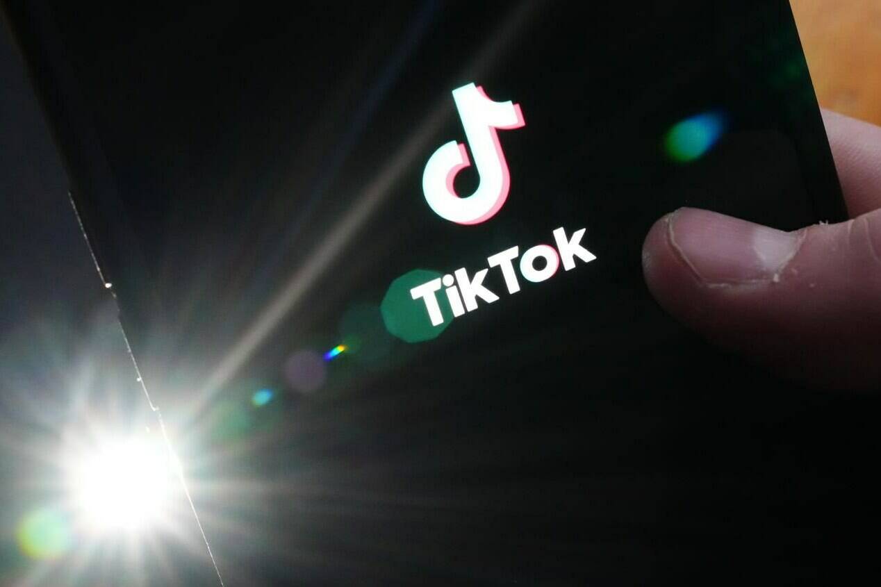 The TikTok startup page is displayed on an iPhone in Ottawa on Monday, Feb. 27, 2023. The University of British Columbia is encouraging students to uninstall the TikTok app from their mobile phones, citing concerns about data sharing with the social media platform’s Chinese parent company. THE CANADIAN PRESS/Sean Kilpatrick