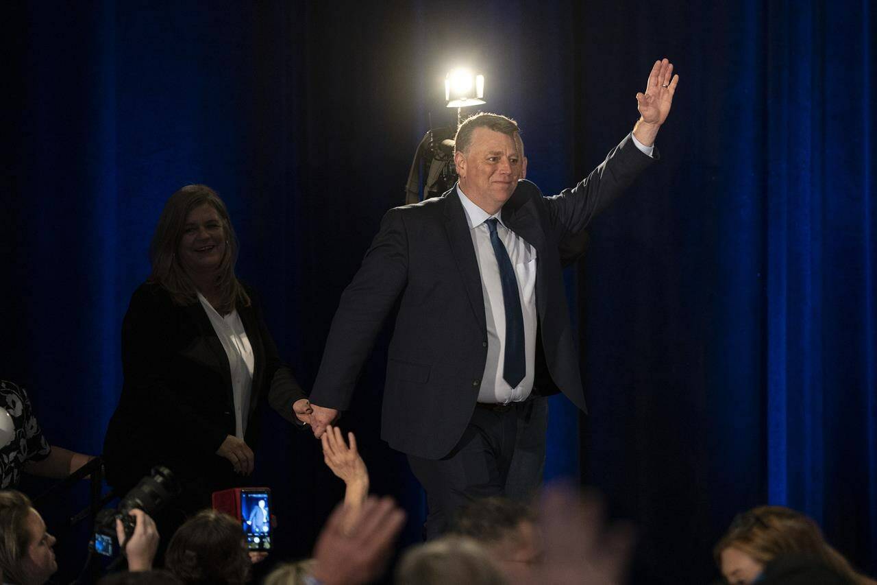 Dennis King, right, leader of the Progressive Conservative Party of P.E.I., arrives with his wife Jana Hemphill to celebrate a majority government with supporters at his election night headquarters in Charlottetown, P.E.I. on Monday, April 3, 2023. THE CANADIAN PRESS/Darren Calabrese