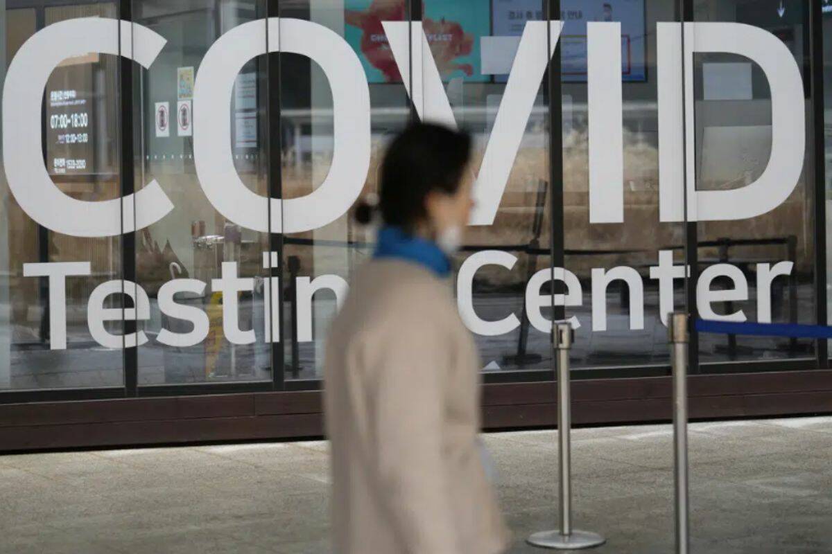 FILE - A woman walks outside of a COVID-19 testing center at the Incheon International Airport In Incheon, South Korea, on Feb. 10, 2023. Officials at the Korea Disease Control and Prevention Agency said Wednesday, April 5, that wastewater surveillance will potentially provide a cheaper and more sustainable tool in the country’s pandemic response. They say it could also improve the detection of other outbreaks, such as influenza, norovirus or drug-resistant bacteria. (AP Photo/Lee Jin-man, File)