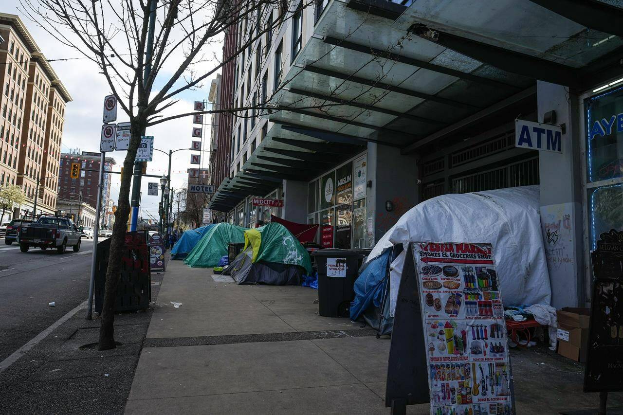 Tents are seen on the sidewalk in the Downtown Eastside of Vancouver, B.C., Monday, April 3, 2023.The City of Vancouver says it has asked police to help bring a tent encampment in the Downtown Eastside neighbourhood to a close.THE CANADIAN PRESS/Darryl Dyck