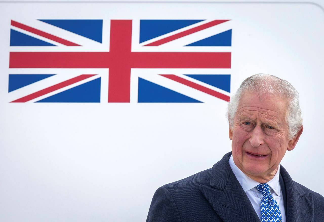 FILE - Britain’s King Charles III stands in front of the plane after arriving at Berlin Airport in Berlin, Germany, Wednesday, March 29, 2023. King Charles III for the first time has signaled support for research into the British monarchy’s ties to slavery. A Buckingham Palace spokesperson made the announcement Thursday, April 6 after a document showed an ancestor of his with shares in a slave-trading company. (Britta Pedersen/dpa via AP, File)