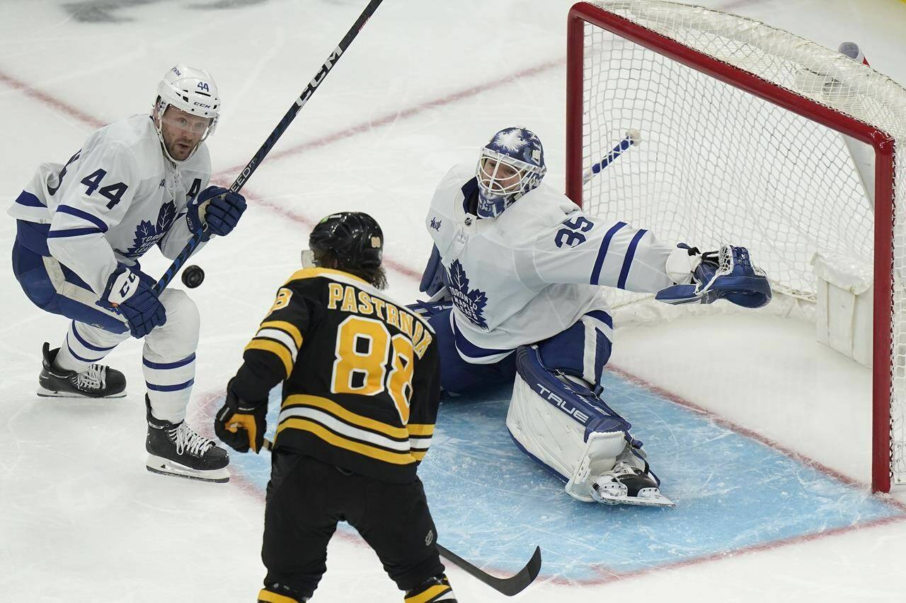 Boston Bruins right wing David Pastrnak (88) tries to get the puck past Toronto Maple Leafs goaltender Ilya Samsonov (35) as Maple Leafs defenseman Morgan Rielly (44) defends in the third period of an NHL hockey game, Thursday, April 6, 2023, in Boston. (AP Photo/Steven Senne)