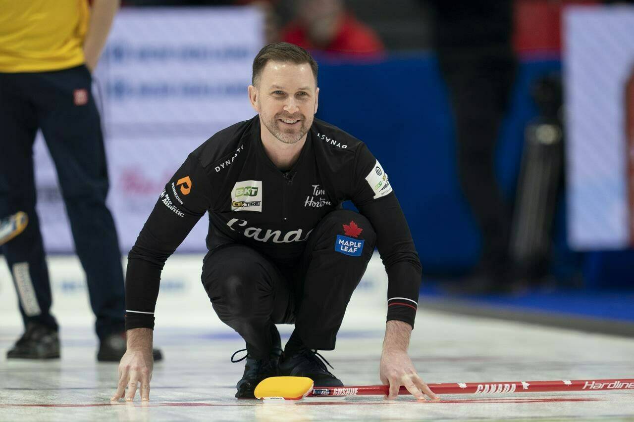 Canadian skip Brad Gushue smiles as his shot enters the house during fifth end action against Team Sweden in the qualification game at the Men’s World Curling Championship, Saturday, April 8, 2023 in Ottawa. THE CANADIAN PRESS/Adrian Wyld
