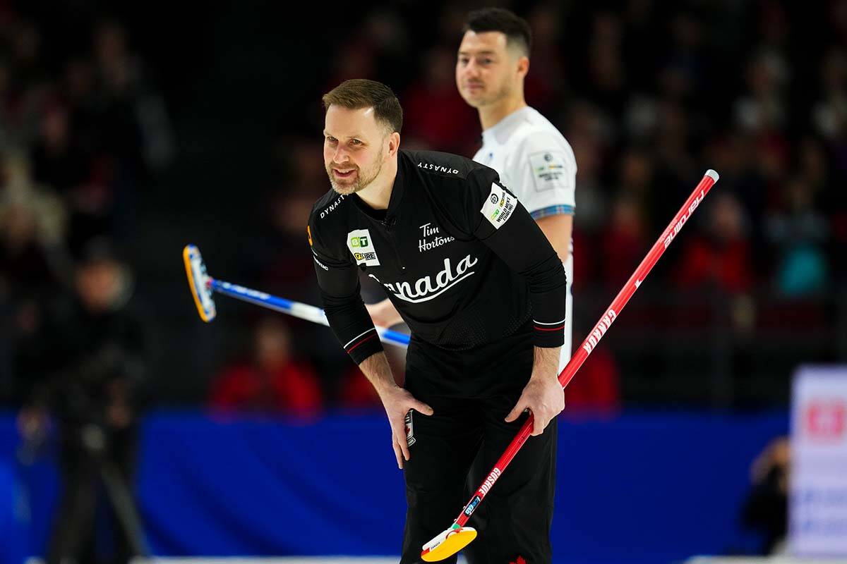Canada skip Brad Gushue watches his shot as Scotland lead Hammy McMillan looks in in the second end of the gold medal game at the Men’s World Curling Championship in Ottawa on Sunday, April 9, 2023. THE CANADIAN PRESS/Sean Kilpatrick