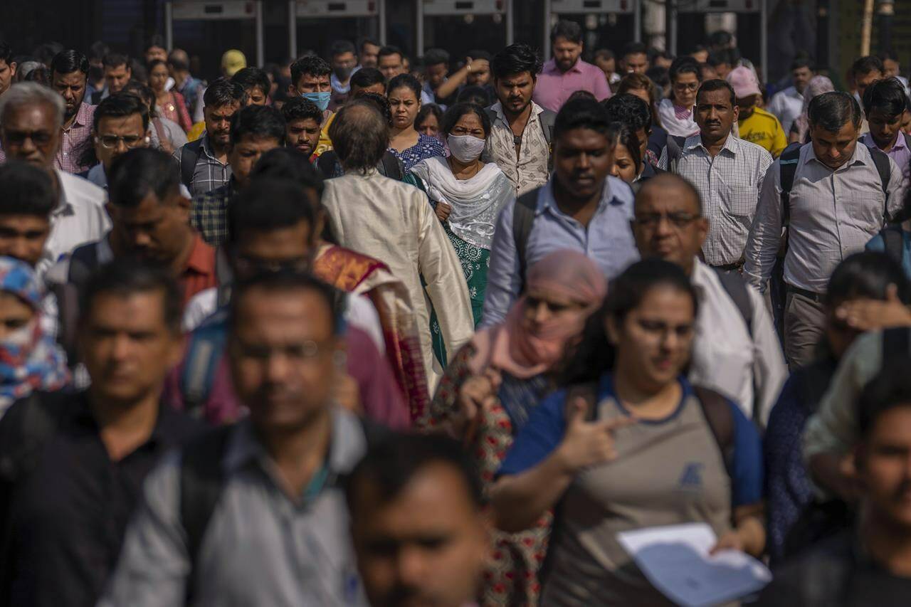 FILE - Indian commuters leave at Chhatrapati Shivaji Maharaj train terminus in Mumbai, India, Monday, Nov. 14, 2022. Demographers are unsure exactly when India will take the title as the most populous nation in the world because they’re relying on estimates to make their best guess. (AP Photo/Rafiq Maqbool, File)