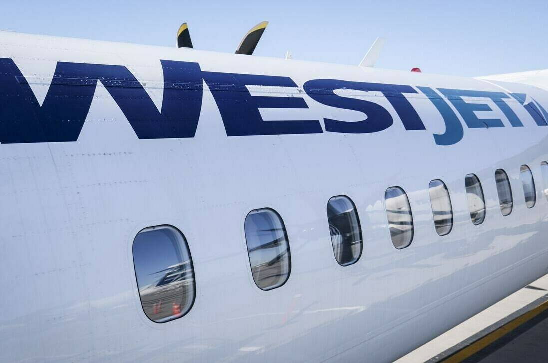 A WestJet plane waits at a gate at Calgary International Airport in Calgary, Alta., Wednesday, Aug. 31, 2022.THE CANADIAN PRESS/Jeff McIntosh