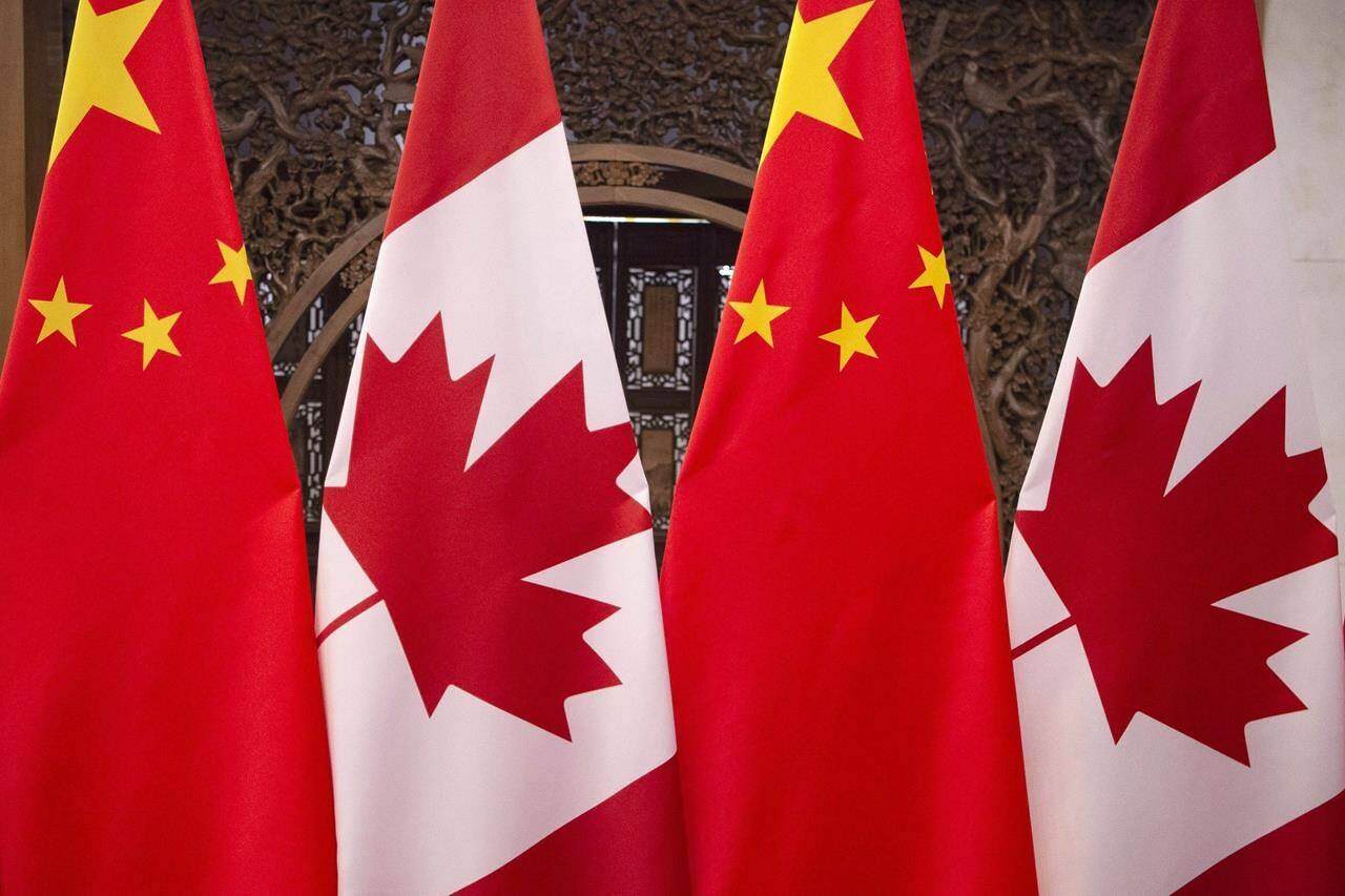 This Dec. 5, 2017, photo shows flags of Canada and China in Beijing. The CEO and the board of directions for the Pierre Elliott Trudeau Foundation say they are stepping down because of recent politicization surrounding their work. THE CANADIAN PRESS/AP, Fred Dufour, Pool Photo