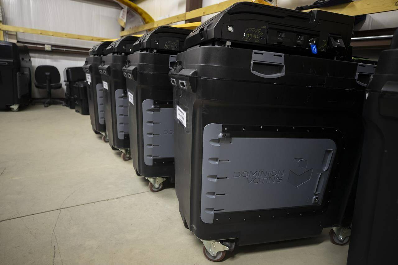 FILE - Dominion Voting ballot counting machines are lined up at a Torrance County warehouse during a testing of election equipment in Estancia, N.M., on Sept. 29, 2022. The judge presiding over a voting machine company’s closely watched defamation lawsuit against Fox News for airing bogus allegations of fraud in the 2020 election indicated Tuesday that he would not allow jurors to hear testimony about specific threats directed at the company. (AP Photo/Andres Leighton, File)