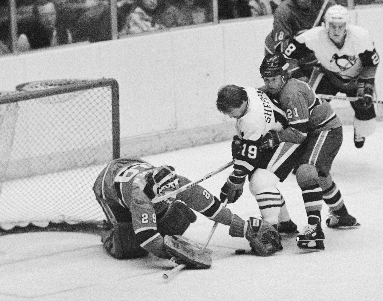 In this Wednesday, Jan. 31, 1979 file photo, goalie Ken Dryden reaches to cover the puck in front of his net during a National Hockey League game against Pittsburgh. For which team did Dryden play? (AP Photo/R.C. Greenawalt, File)