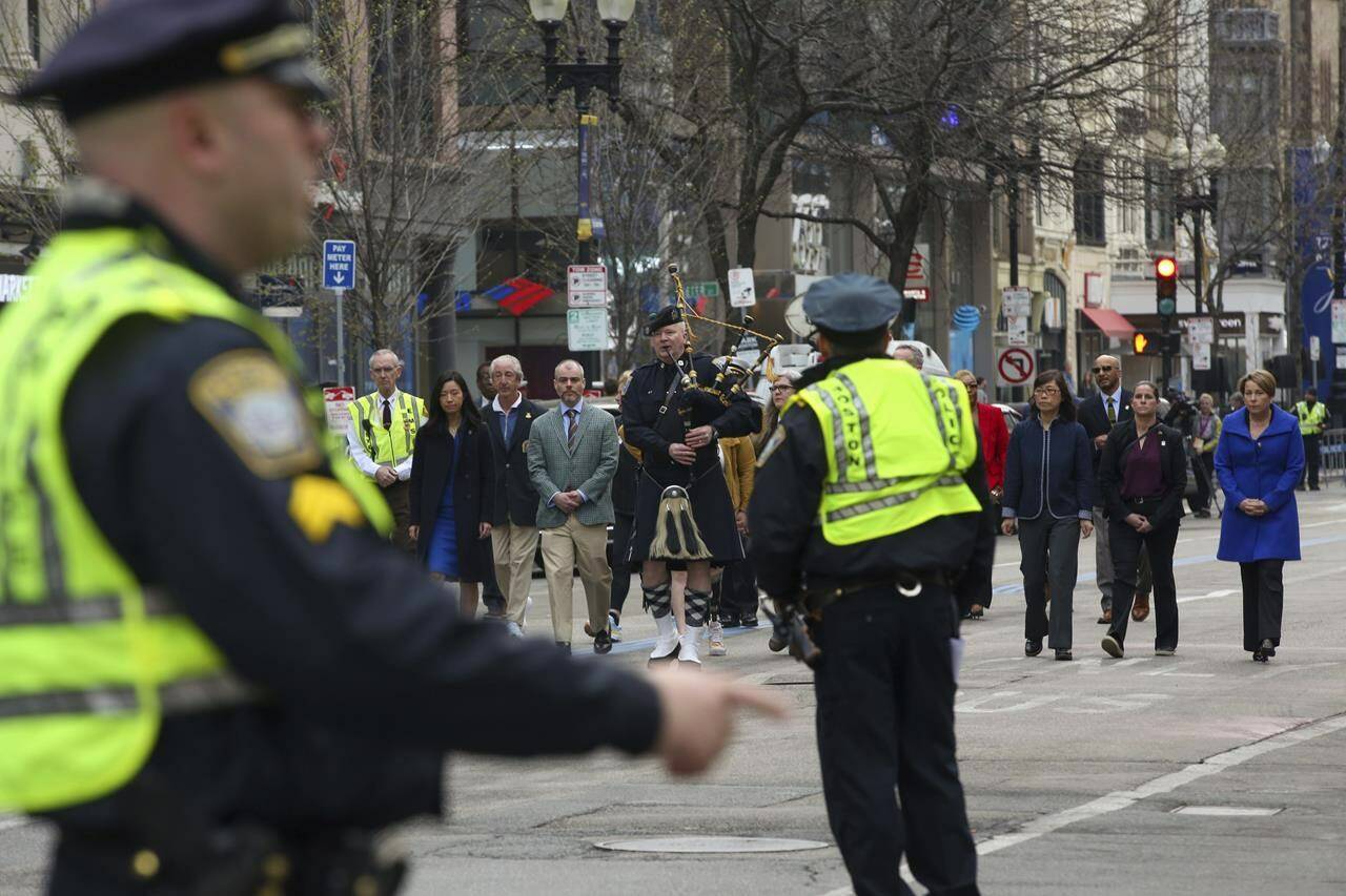 Boston Police clear Boylston Street for a procession between memorials for victims of the 2013 Boston Marathon bombing, Saturday April 15, 2023, in Boston. (AP Photo/Reba Saldanha)