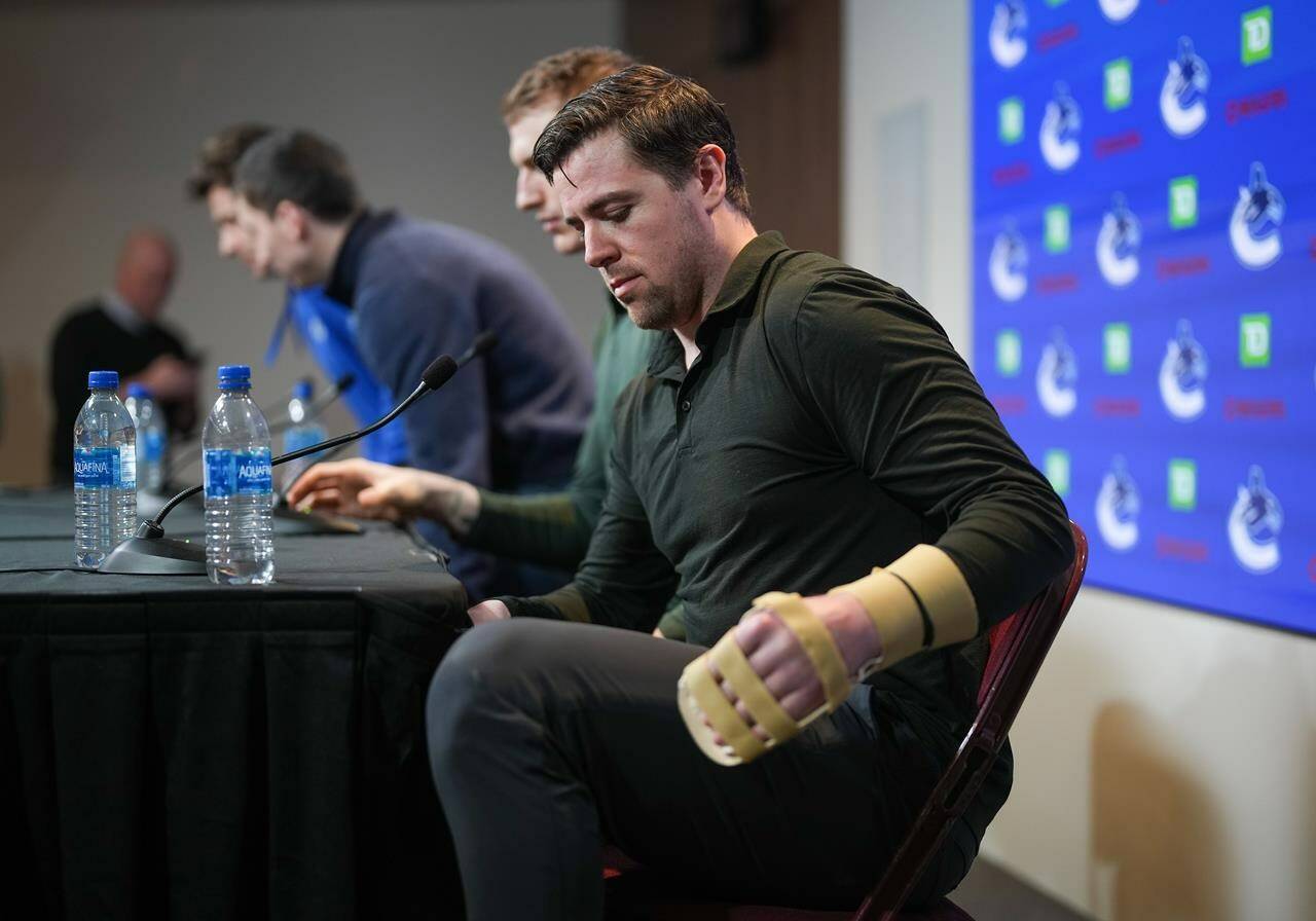 Vancouver Canucks left-winger Tanner Pearson, who broke his hand during a game last November, stands to leave after the NHL hockey team’s end of season news conference, in Vancouver, on Saturday, April 15, 2023. THE CANADIAN PRESS/Darryl Dyck