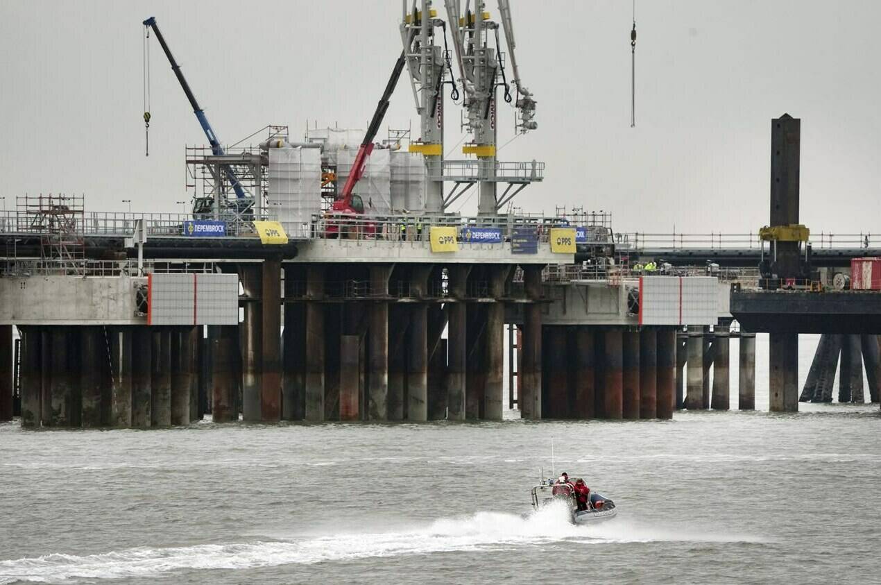 A police boat drives past the construction site of the ‘Uniper’ LNG (Liquefied Natural Gas) terminal in Wilhelmshaven, Germany, Tuesday, Nov. 15, 2022. THE CANADIAN PRESS/AP-Michael Sohn