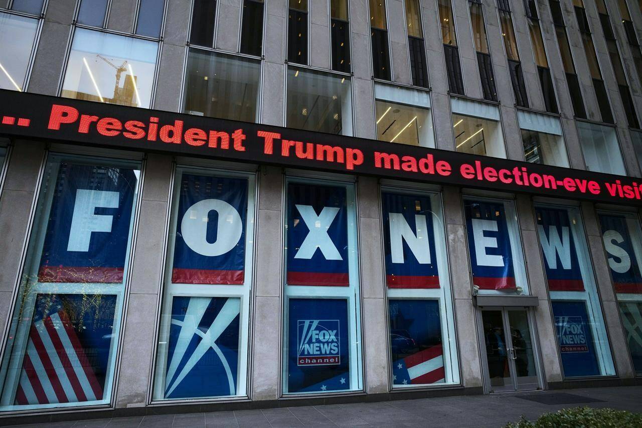 FILE - A headline about President Donald Trump is displayed outside Fox News studios in New York on Nov. 28, 2018. The Delaware judge overseeing Dominion Voting Systems’ $1.6 billion defamation lawsuit against Fox News announced late Sunday, April 16, that he was delaying the start of the trial until Tuesday, April 18. He did not cite a reason. The trial, which has drawn international interest, had been scheduled to start Monday morning with jury selection and opening statements. (AP Photo/Mark Lennihan, File)