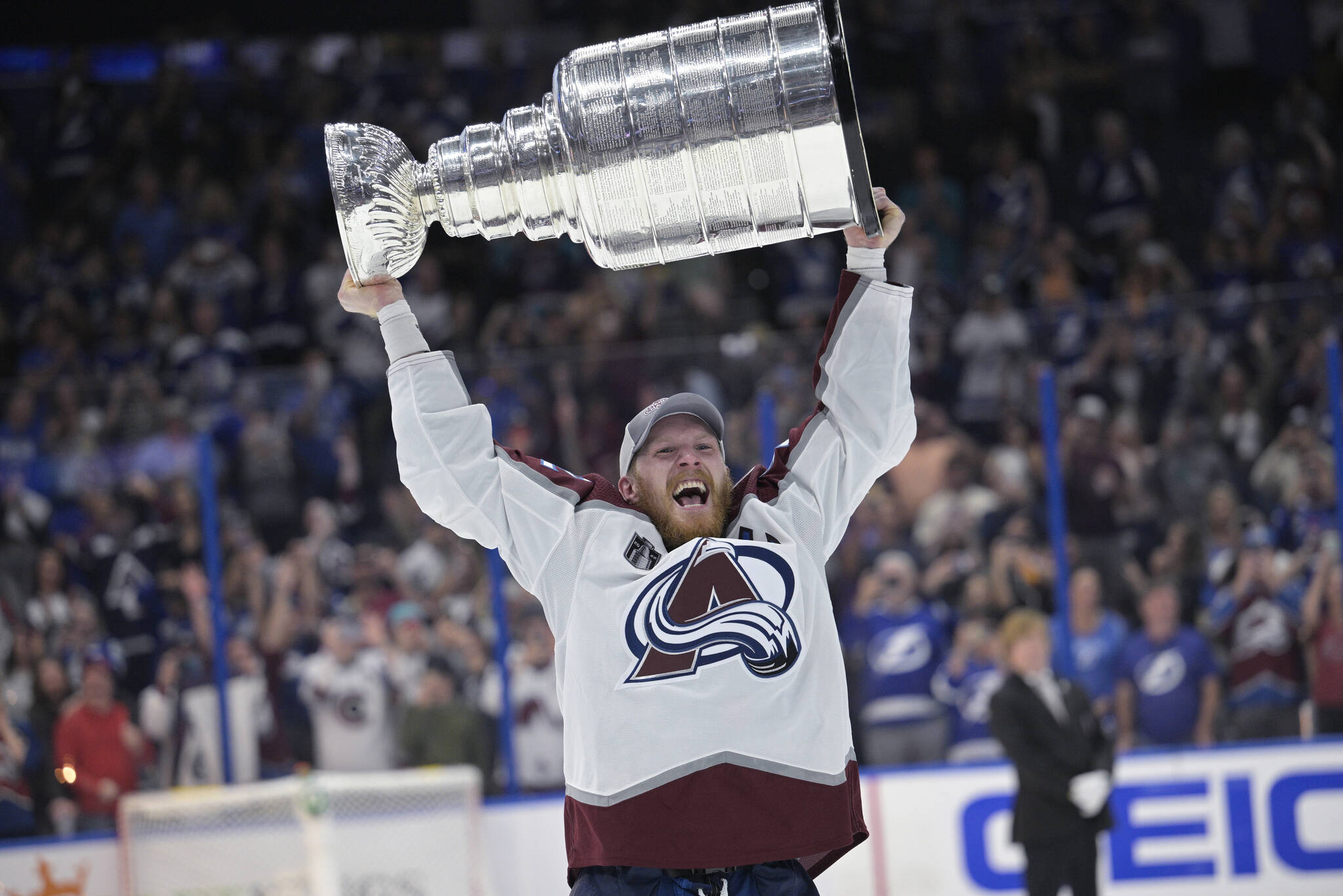 FILE - Colorado Avalanche’s Gabriel Landeskog lifts the Stanley Cup after the team defeated the Tampa Bay Lightning in Game 6 of the NHL hockey Stanley Cup Finals on June 26, 2022, in Tampa, Fla. The Avalanche will have to try to defend their Stanley Cup championship without Landeskog. The team announced Thursday, April 13, that Landeskog will not take part in the playoffs because of a knee injury that caused him to miss the entire regular season. (AP Photo/Phelan M. Ebenhack, File)