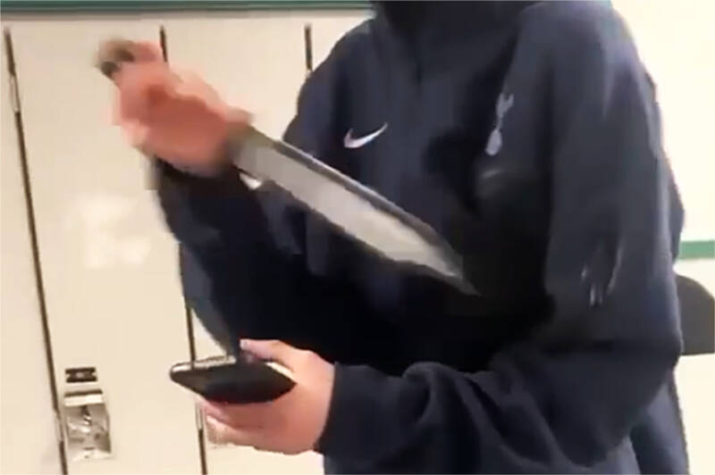 A still image taken from a submitted video of an altercation at Nanaimo District Secondary School shows a large knife that was wielded by a youth in the school hallway. A 15-year-old was arrested by police Monday, April 17, soon after the incident. (Image submitted)