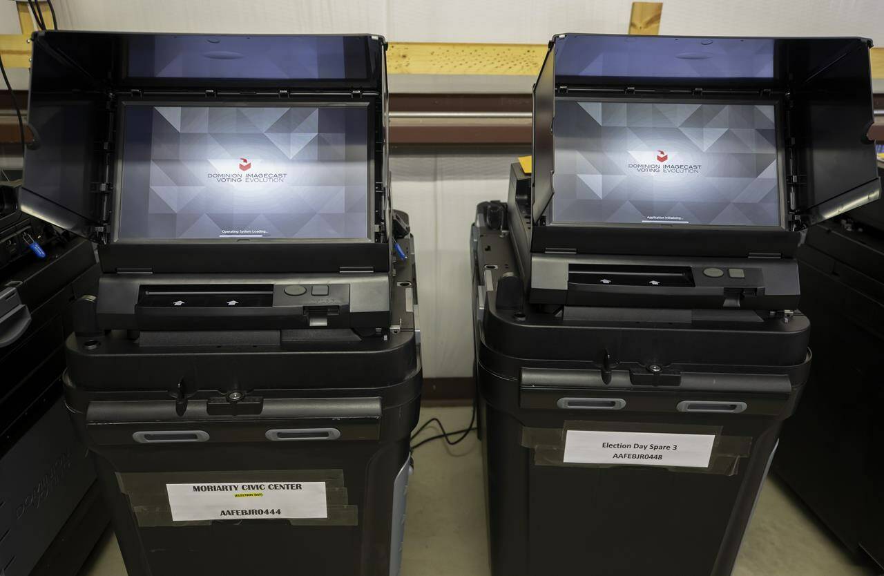 FILE - Dominion Voting ballot-counting machines are shown at a Torrance County warehouse during election equipment testing with local candidates and partisan officers in Estancia, N.M., Sept. 29, 2022. Dominion Voting Systems’ defamation lawsuit against Fox News for airing bogus allegations of fraud in the 2020 election is set to begin trial on Tuesday, April 18, 2023, in Delaware. (AP Photo/Andres Leighton, File)