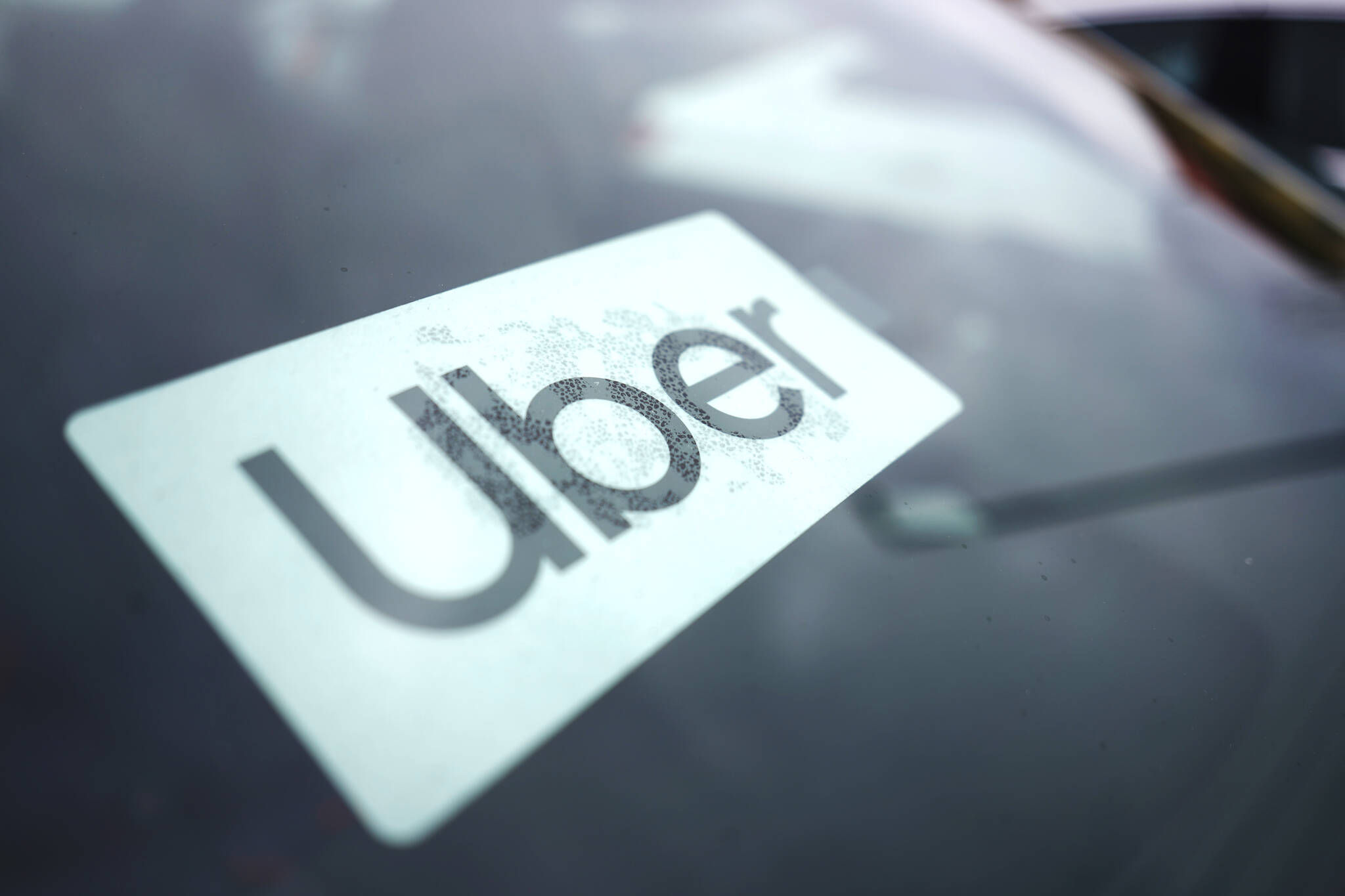 FILE - An Uber sign is displayed inside a car in Palatine, Ill., Thursday, Feb. 10, 2022. (AP Photo/Nam Y. Huh, File)