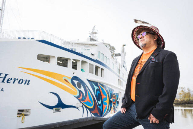 Maynard Johnny Jr. looks over the Salish Heron, featuring his design, at BC Ferries Fleet Maintenance Unit in Richmond. Johnny is one of 14 artists featured along with legend Bill Reid in the Bright Futures exhibition. (Photo by BC Ferries)