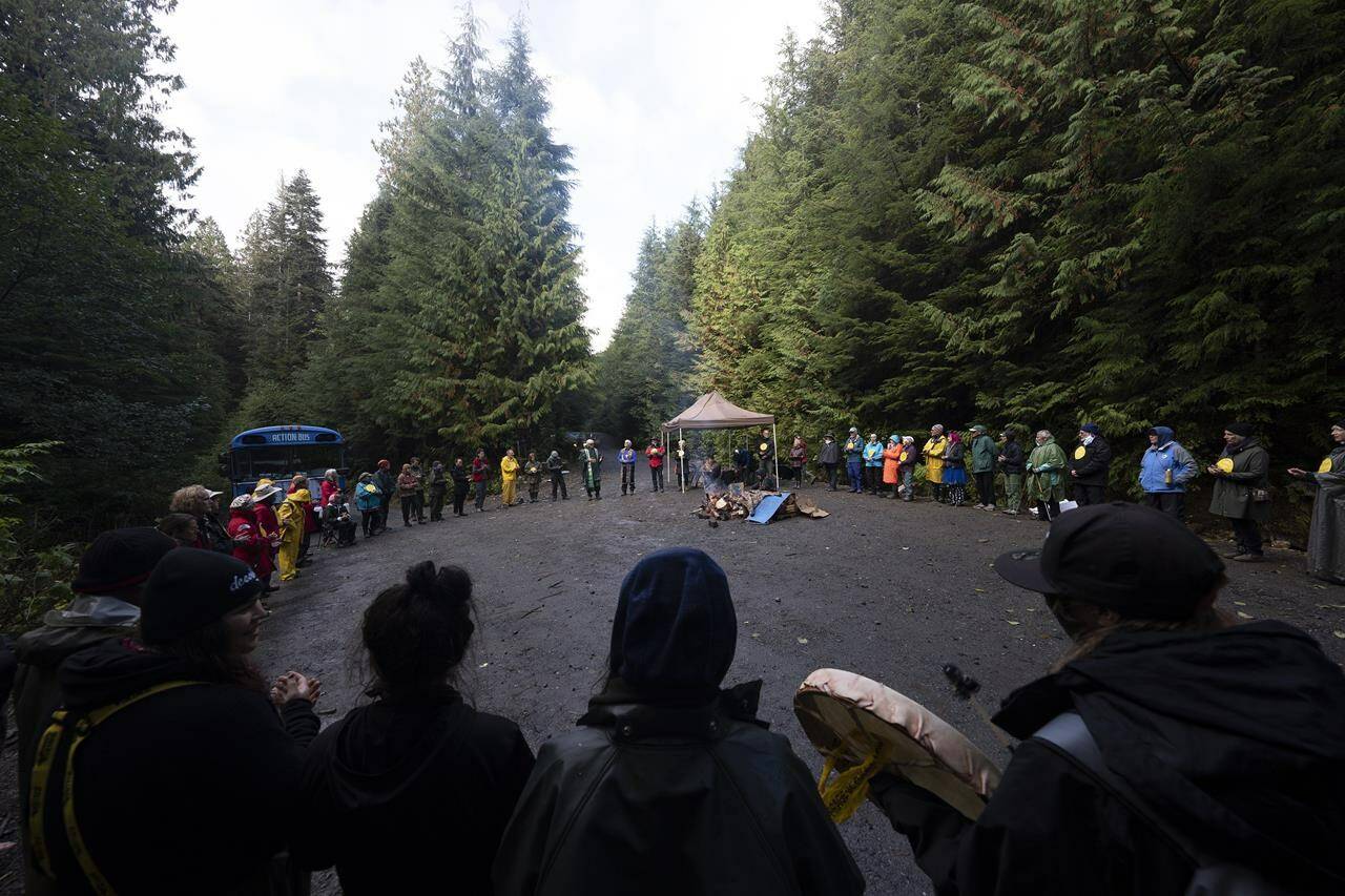 People take part in a peace circle along a logging road in the Fairy Creek logging area near Port Renfrew, B.C., on Tuesday, Oct. 5, 2021. The B.C. Prosecution Service says it has withdrawn contempt charges against 11 old-growth logging protesters accused of breaching a court injunction during blockades at Fairy Creek on Vancouver Island.THE CANADIAN PRESS/Jonathan Hayward
