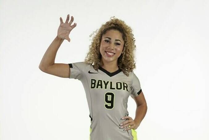 In this photo provided by Baylor University, Payton Washington poses in an undated photo wearing Baylor University attire. Washington was one of two cheerleaders shot and wounded by a man in a Texas supermarket parking lot after one of them said she mistakenly got into his car thinking it was her own. (Baylor University via AP)