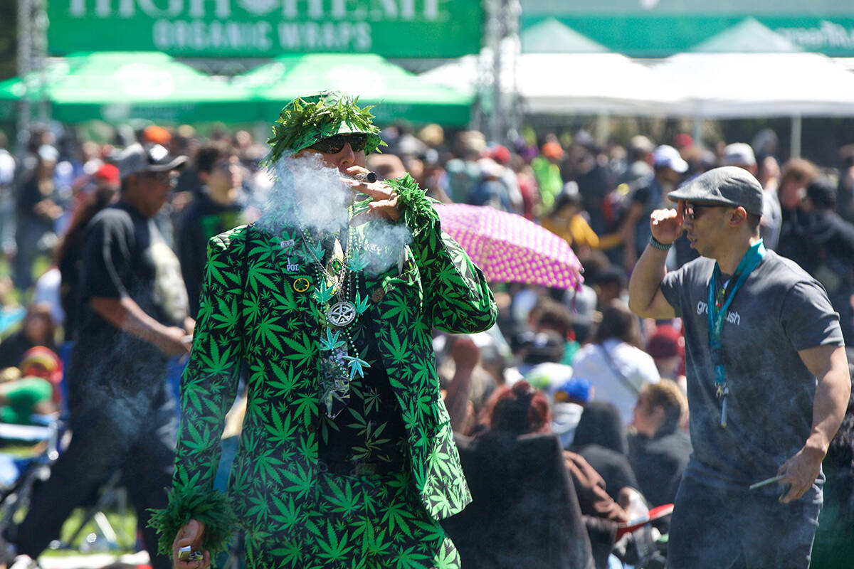 Mike Barnes of Hayward smokes while dressed in a marijuana leaf suit during the 420 event at Hippie Hill in Golden Gate Park on Friday, April 20, 2018. (Kevin N. Hume/S.F. Examiner)