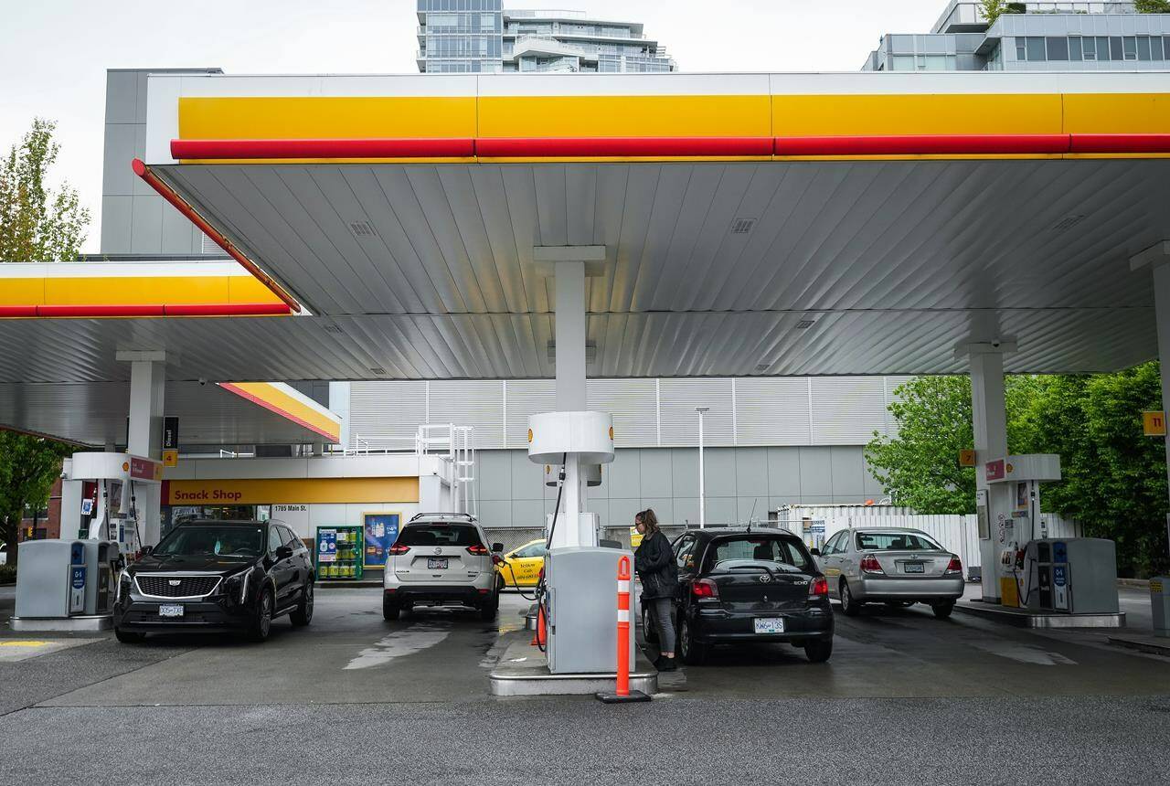 People fuel up vehicles in Vancouver, on Saturday, May 14, 2022. Statistics Canada says retail sales fell 0.2 per cent to $66.3 billion in February as a drop in sales at gasoline stations and fuel vendors and general merchandise stores led the way lower. THE CANADIAN PRESS/Darryl Dyck