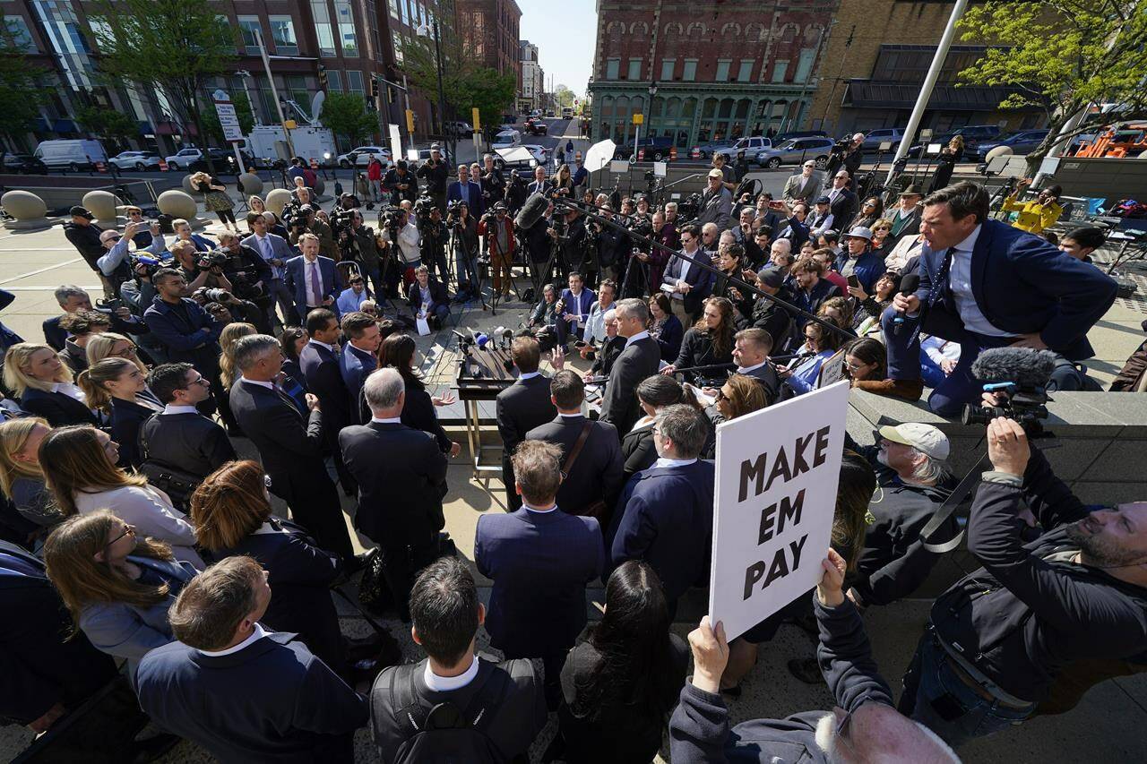 File - Reporters surround attorneys for Dominion Voting Systems during a news conference outside the New Castle County Courthouse in Wilmington, Del., after the defamation lawsuit by Dominion against Fox News was settled on Tuesday, April 18, 2023. Fox Corp.’s hefty $787.5 million settlement with Dominion over defamation charges is unlikely to make a dent in Fox’s operations, analysts say. (AP Photo/Julio Cortez, File)