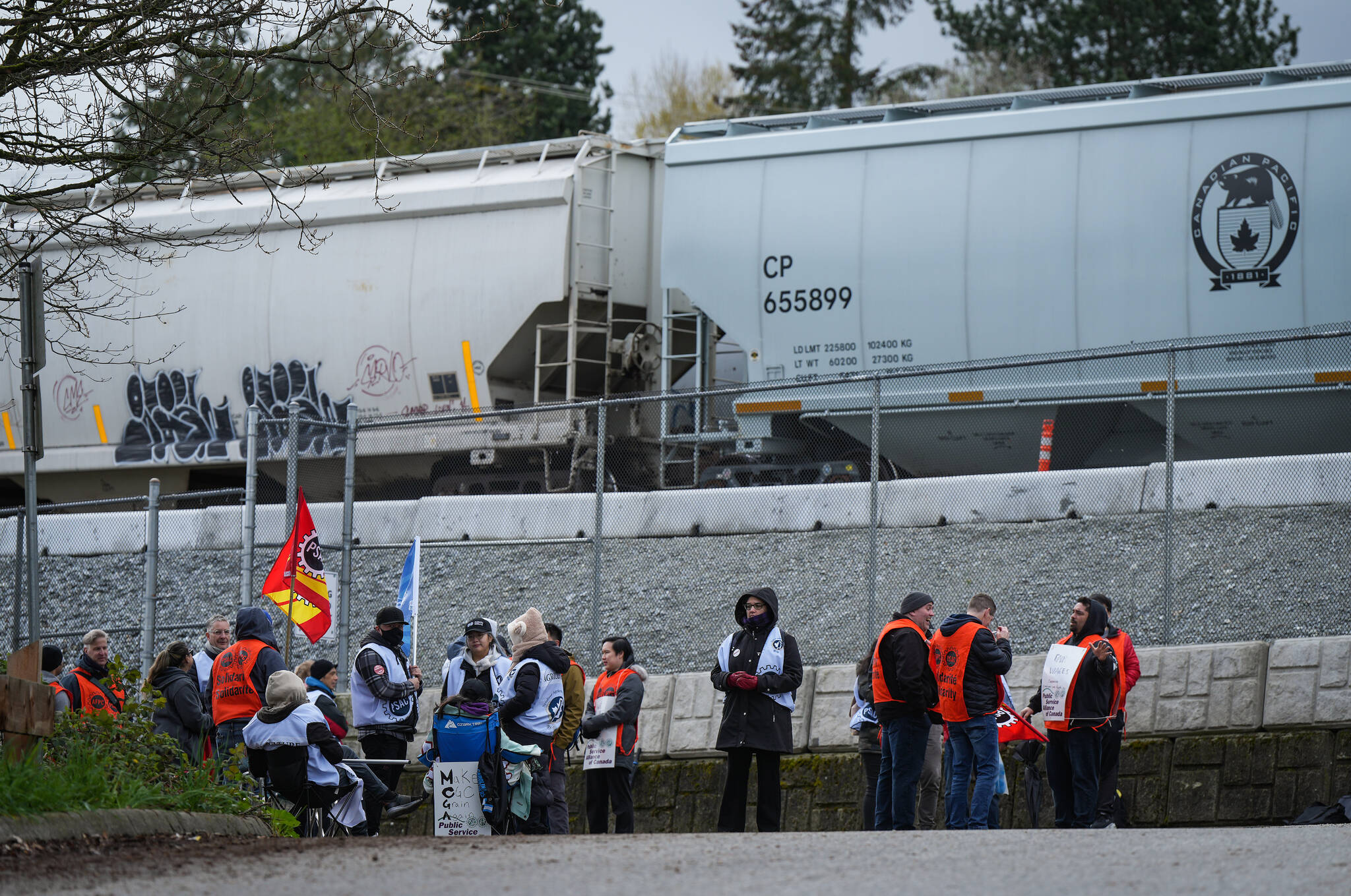 Public Service Alliance of Canada members who are employees at the Canadian Grain Commission picket outside the Viterra Cascadia Terminal, in Vancouver, on Monday, April 24, 2023. The grain terminal handles wheat, durum, canola, barley, rye, oats and by-products that arrive by rail and are loaded on bulk carrier ships for export. THE CANADIAN PRESS/Darryl Dyck