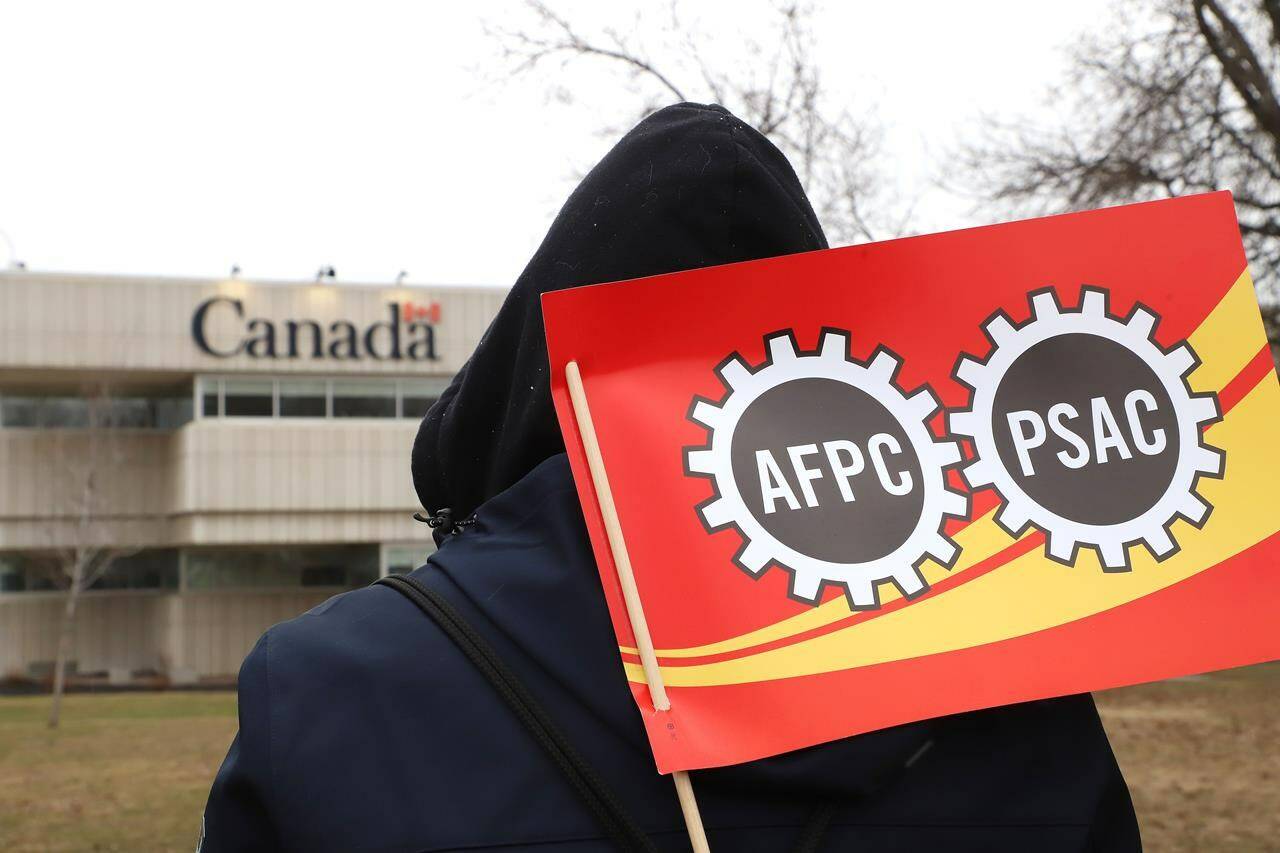 PSAC workers and supporters picket outside the Canada Revenue Agency office in Sudbury, Ont. on Wednesday, April 19, 2023. There are calls to extend this year’s tax deadline amid a federal public service strike that some fear is making it hard for some people to file on time. THE CANADIAN PRESS/Gino Donato