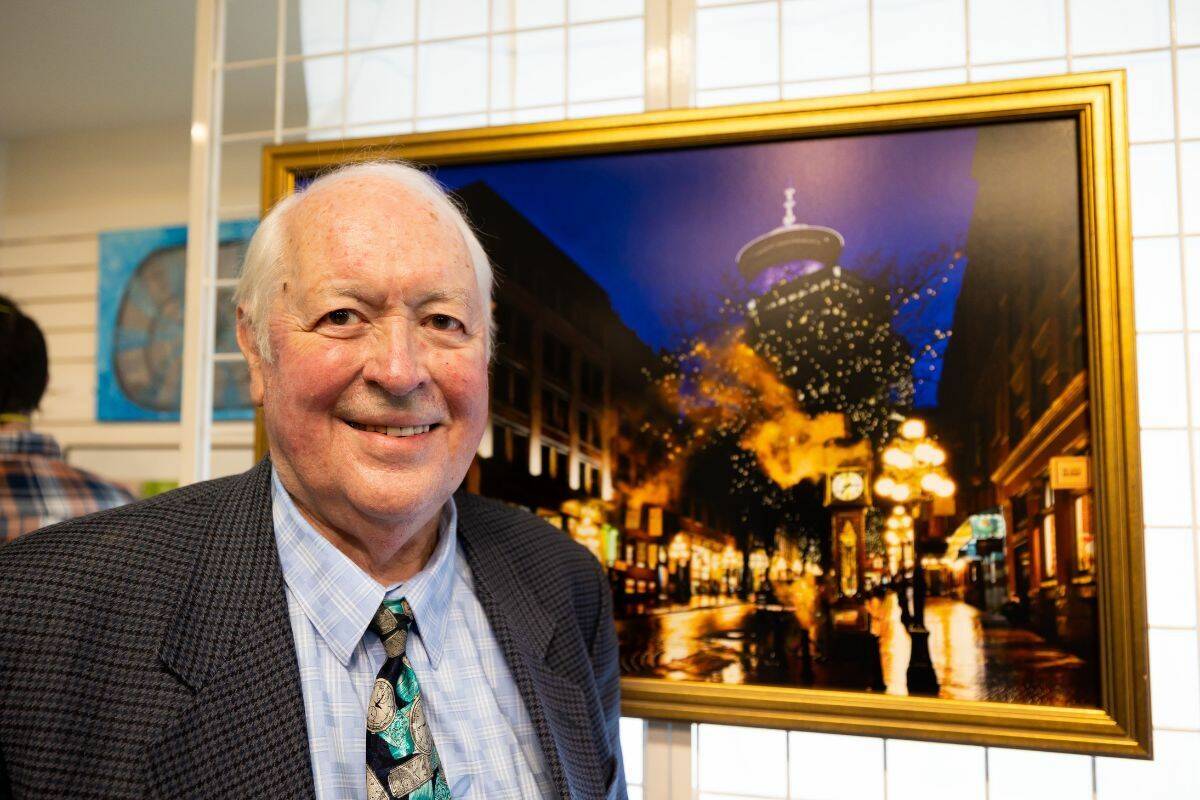 Raymond Saunders in front of Helmut Gruntorad’s photograph of Gastown’s famous steam clock at Newton Cultural Centre in Surrey on April 22. Saunders was commissioned to make the steam clock in 1977. (Photo: Anna Burns)