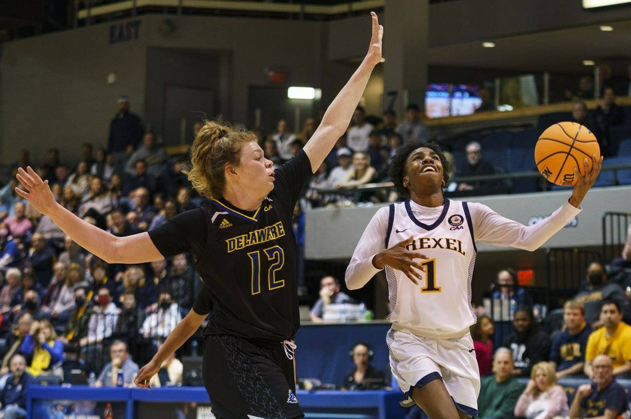 Drexel’s Keishana Washington, right, controls the ball against Delaware’s Lizzie Oleary, left, during the second half of an NCAA college basketball championship game in the Colonial Athletic Association Conference tournament Sunday, March 13, 2022, in Philadelphia. Washington, who recently closed out her NCAA career at Drexel University, signed a training camp deal with the WNBA’s Minnesota Lynx on April 14. THE CANADIAN PRESS/AP-Chris Szagola