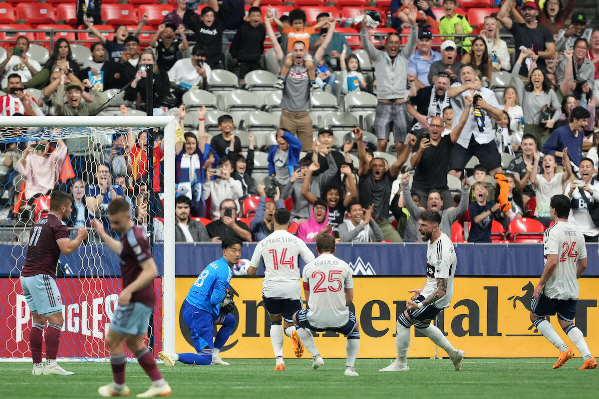 Vancouver Whitecaps goalkeeper Yohei Takaoka, third left, holds the ball after stopping Colorado Rapids’ Diego Rubio, left, on a penalty kick as Vancouver’s Luis Martins (14), Ryan Gauld (25), Tristan Blackmon, second right, and Brian White (24) celebrate during the second half of an MLS soccer game in Vancouver, on Saturday, April 29, 2023. THE CANADIAN PRESS/Darryl Dyck