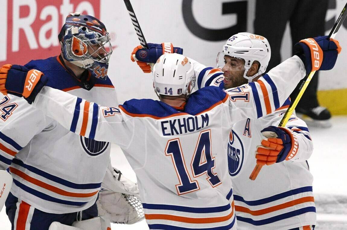 Edmonton Oilers goalie Stuart Skinner, left, celebrates with teammates Mattias Ekholm (14) and Darnell Nurse after the team’s win over the Los Angeles Kings in Game 6 of an NHL hockey Stanley Cup first-round playoff series in Los Angeles on Saturday, April 29, 2023. (Keith Birmingham/The Orange County Register via AP)