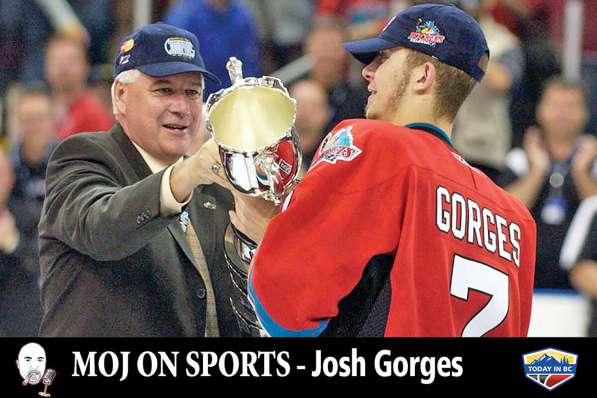 Bruce Hamilton hands the Memorial Cup to team captain Josh Gorges after the host Kelowna Rockets won the Canadian Hockey League championship in 2004. (Capital News)