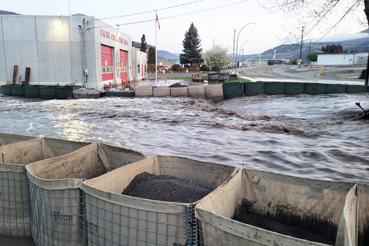 Water from Cache Creek flows between two rows of Hesco barriers after overwhelming the culvert at Quartz Road on the morning of May 2. (Photo credit: Cache Creek Volunteer Fire Department)
