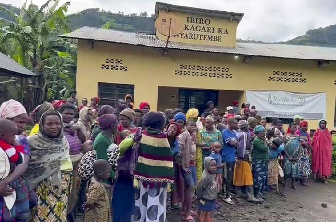 People gather after flooding in western Rwanda on Wednesday, May 3, 2023. Torrential rains caused flooding in western and northern Rwanda, killing more than 100 people, a public broadcaster said Wednesday. (RwandaTV via AP)