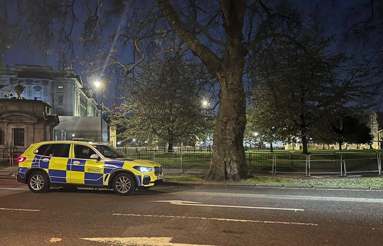 A police car outside Buckingham Palace, London, Tuesday, May 2, 2023. London police say a controlled explosion has been carried out as a precaution outside Buckingham Palace after a man was arrested on suspicion of possessing an offensive weapon. The Metropolitan Police force said officers arrested the man after he approached the palace gates on Tuesday night and threw items suspected to be shotgun cartridges onto the grounds. (Ben Roberts-Haslam/PA via AP)