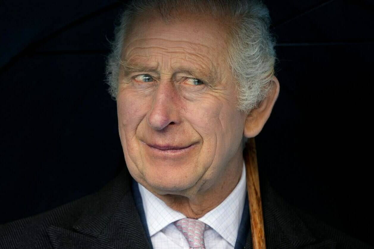 FILE - Britain’s King Charles III smiles during a boat trip, in Hamburg, Germany, Friday, March 31, 2023. King Charles III arrived Wednesday for a three-day official visit to Germany. Britain’s royal family turns the page on a new chapter with the coronation of King Charles III. Charles ascended the throne when his mother, Queen Elizabeth II, died last year. But the coronation Saturday is a religious ceremony that provides a more formal confirmation of his role as head of state and titular head of the Church of England. (AP Photo/Matthias Schrader, Pool, File)